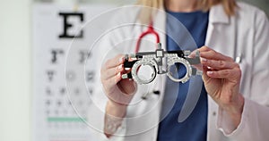 Ophthalmologist holds glasses for vision test