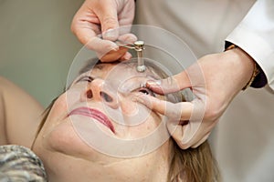 Ophthalmologist measures the ocular tension