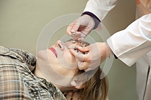 Ophthalmologist measures the ocular tension