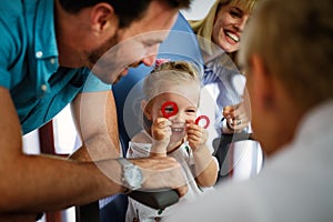 Ophthalmologist, optometrist checking child vision looking for problems and caring for eye