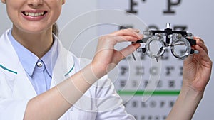 Ophthalmologist showing phoropter, vision checking device, medical equipment