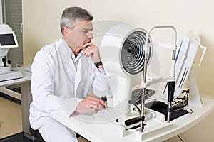 Ophthalmologist sitting near the equipment