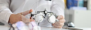 Ophthalmologist with trial frame for selection of complex astigmatic glasses