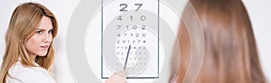 Ophthalmologist using Snellen chart photo