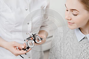 Ophthalmologist woman doctor checks diagnose eyesight young woman.