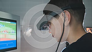 Ophthalmology - child boy checks eyes with stereo glasses and monitor