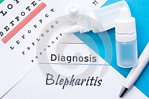 Ophthalmology diagnosis Blepharitis. Snellen eye chart, two bottles of eye drops  medications lying on notebook with inscripti photo