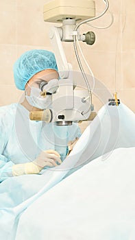 Ophthalmology laser microscope operation. Doctor in clinic. Patient eye treatment. Myopia and cataract removal