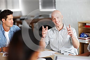 Opinionated entrepreneur. A young man giving his oppinion in a meeting with colleagues.