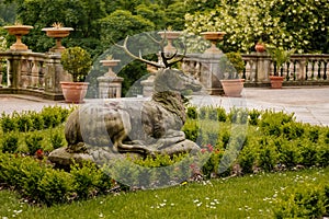 Opocno castle, renaissance chateau, courtyard with arcades and red facade, palm trees and plants in ceramic pots, deer statue,