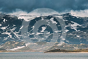 Oppland, Tyin Lake, Norway. Stones On Coast Of Beautiful Lake Tyin In Summer Cloudy Day. Norwegian Nature photo