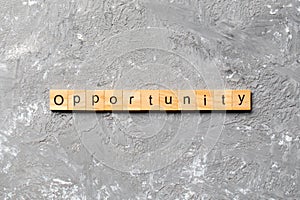 Opportunity word written on wood block. Opportunity text on table, concept