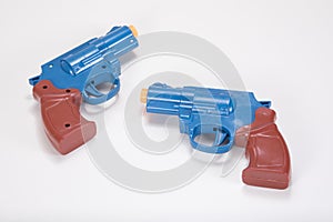 Opposing plastic toy handguns with copy space