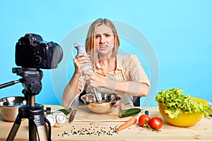 Opps, something goes wrong. Isolated shot of cute blogger girl tries new recipe