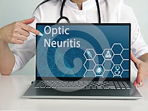 Optic Neuritis text in list. Immunologist looking for something at laptop