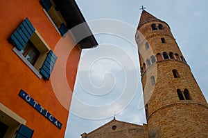 Small italian town view of shop and tower bell with cloudy sky photo