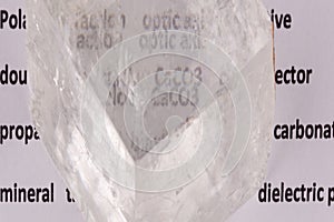 Optical birefringence demonstrated using a text using a natural double spar calcite crystal