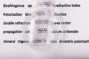 Optical birefringence demonstrated using a text using a natural double spar calcite crystal