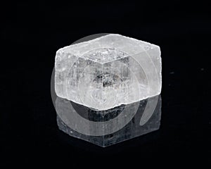 Optical Calcite from China isolated on a black mirror background. Alternative stone name: Iceland Spar