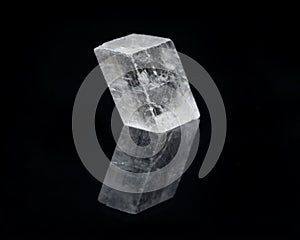 Optical Calcite from China isolated on a black mirror background. Alternative stone name: Iceland Spar