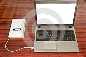 Optical character recognition concept. Book and laptop