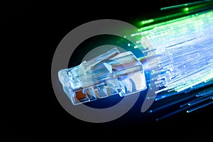 Optical fiber and LAN cable on black background