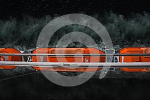 Optical illusion of orange life boats on a ship