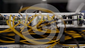 Optical server and router of the data center server room. Network equipment blinking with lights on rack. Optical fiber