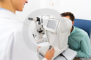 Optician with autorefractor and patient at clinic