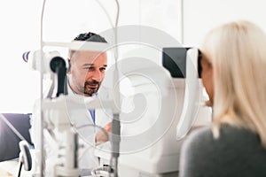 Optician examining his patient`s eyes