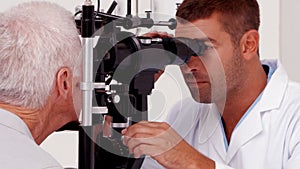 Optician examining a patients eyes