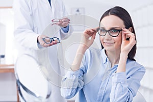 Optician with eyeglasses and client