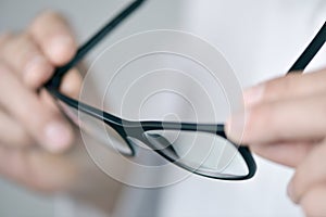 Optician man checking a pair of eyeglasses