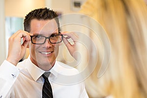 Optician or optometrist consulting a customer about eyeglasses