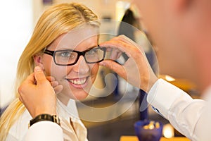 Optician or optometrist consulting a customer about eyeglasses