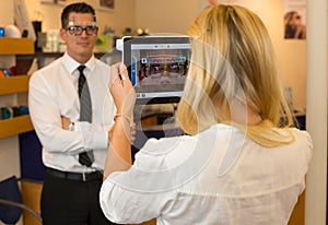 Optician or optometrist measuring the eye distance of a customer