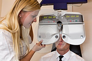 Optician or optometrist and patient with a phoropter