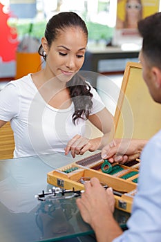 optician selecting lens for eye test