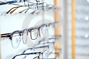 In optician shop- different glasses for sale in wall rack