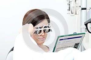 Optician with trial frame, optometrist doctor examines eyesight