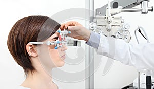 Optician with trial frame, optometrist doctor examines eyesight