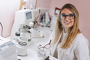 Optician working in optic store