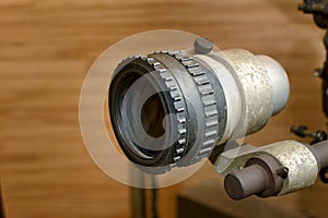 Optics mounted on the turret of a projector.
