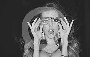 Optics store concept. Girl short sightedness needs modern eyeglasses. Woman with surprised face wears ugly eyeglasses photo