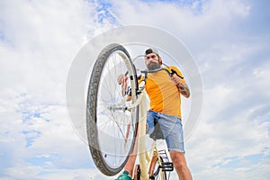 Optimise cycling performance. Man bearded hipster rides bicycle bottom view sky background. Modern bicycle riding