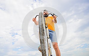 Optimise cycling performance. Man bearded hipster rides bicycle bottom view sky background. Overcome obstacles on bike