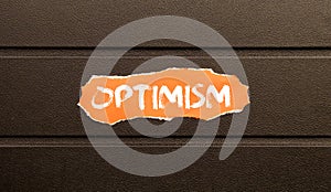 Optimism Word Written In red torn paper