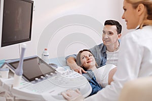 Optimistic couple enjoying appointment at the sonography cabinet