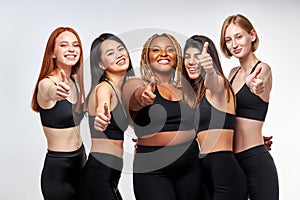 optimistic diverse models showing thumbs up photo