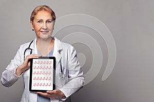 Optimistic doctor using digital tablet with heartbeat concept